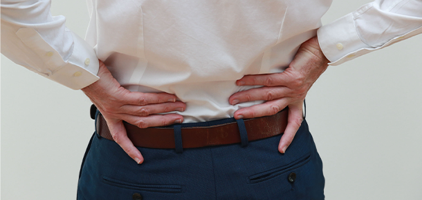 Person holding back in pain 